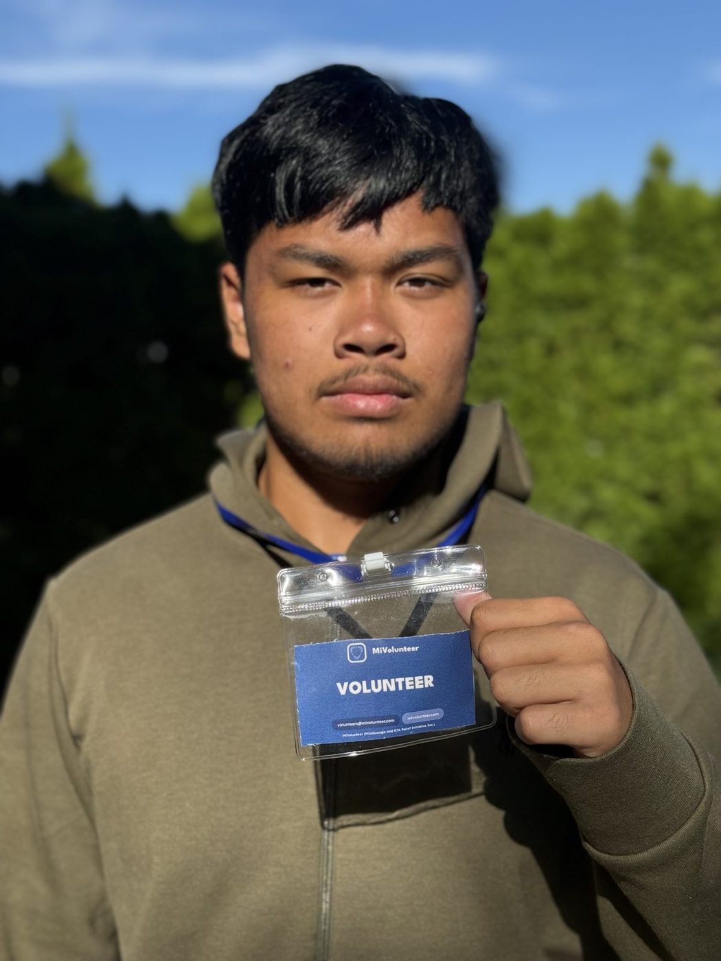 A MiVolunteer volunteer wearing a volunteer badge