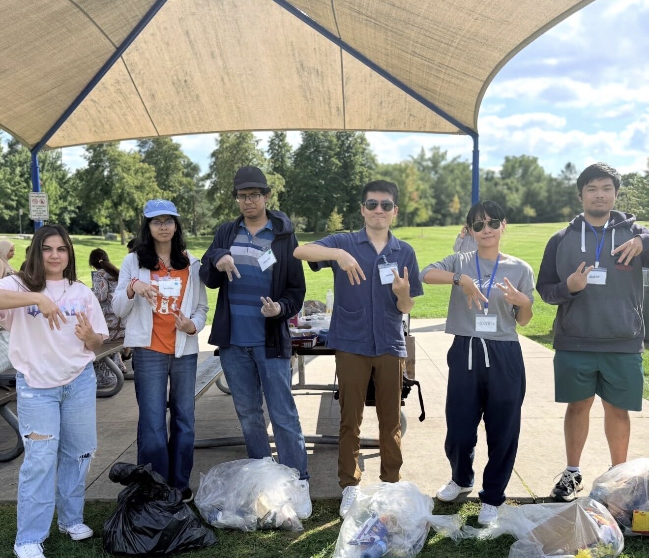 A group of MiVolunteer volunteers at a community park cleanup